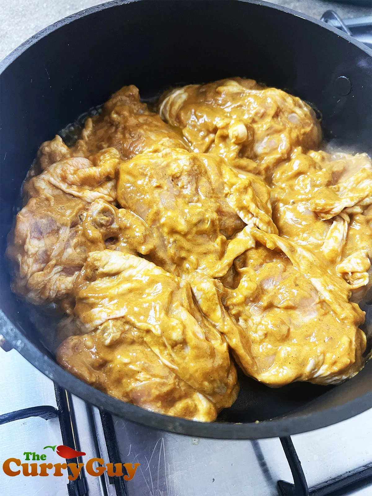 Marinaded chicken in the pot.