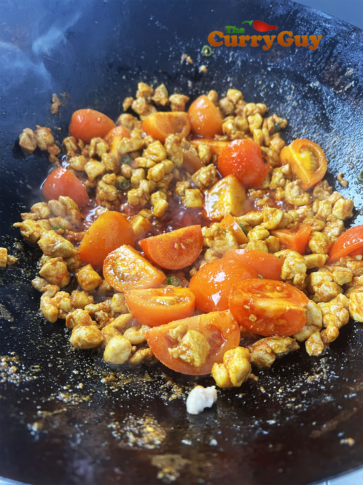 Adding tomatoes to the pan