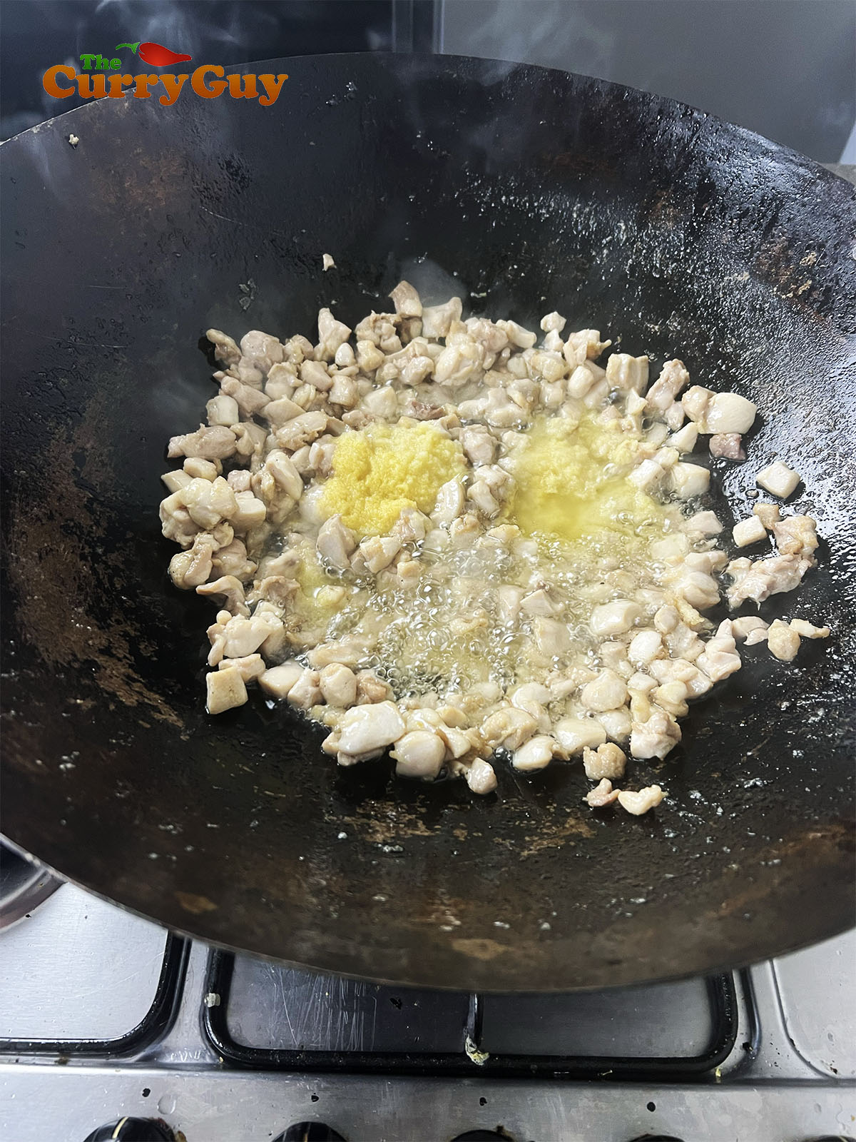 Adding garlic and ginger paste to the karahi
