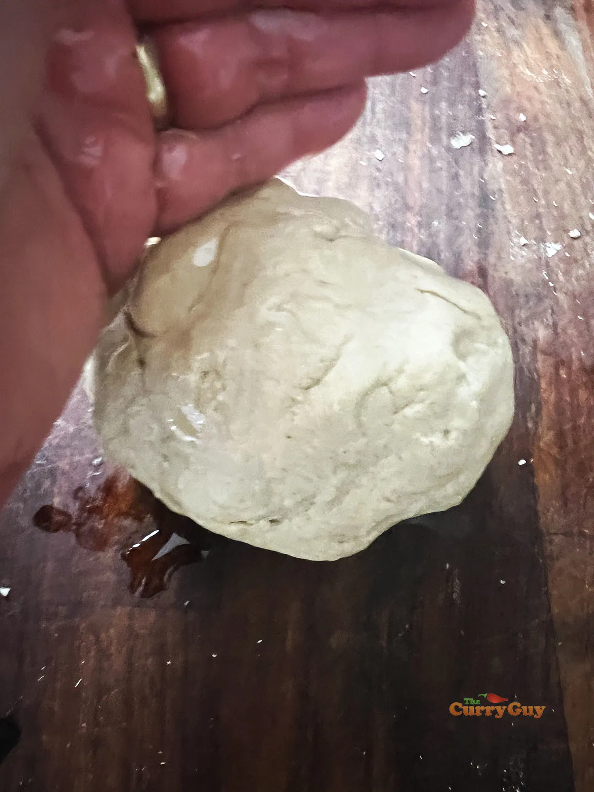 Adding oil and kneading the dough.