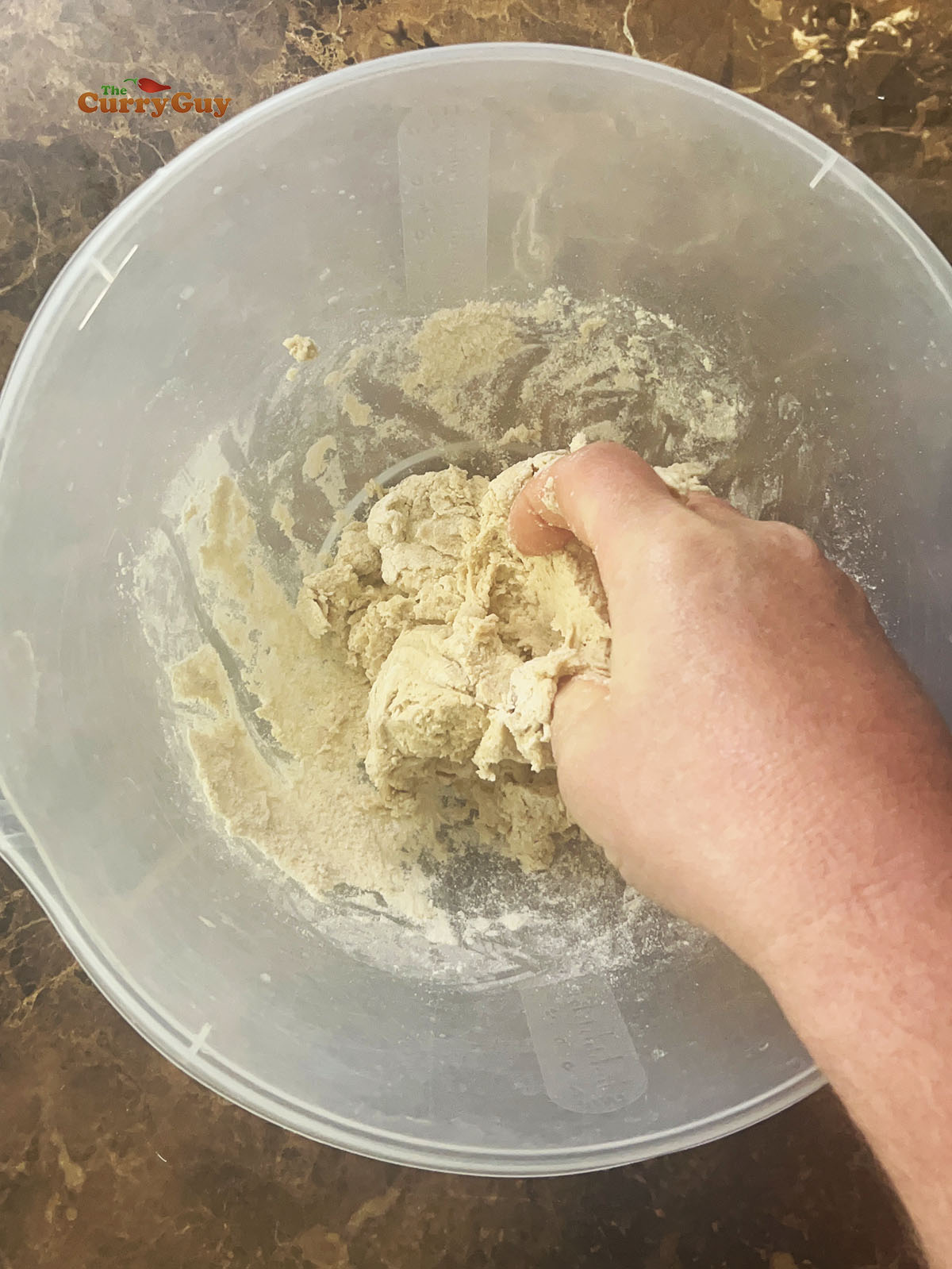 Continuing to slowly add water to form a dough.