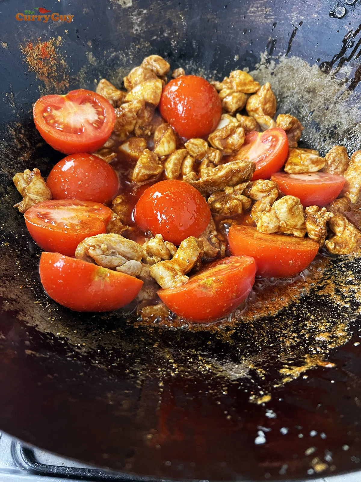 Adding the ground spices and tomatoes