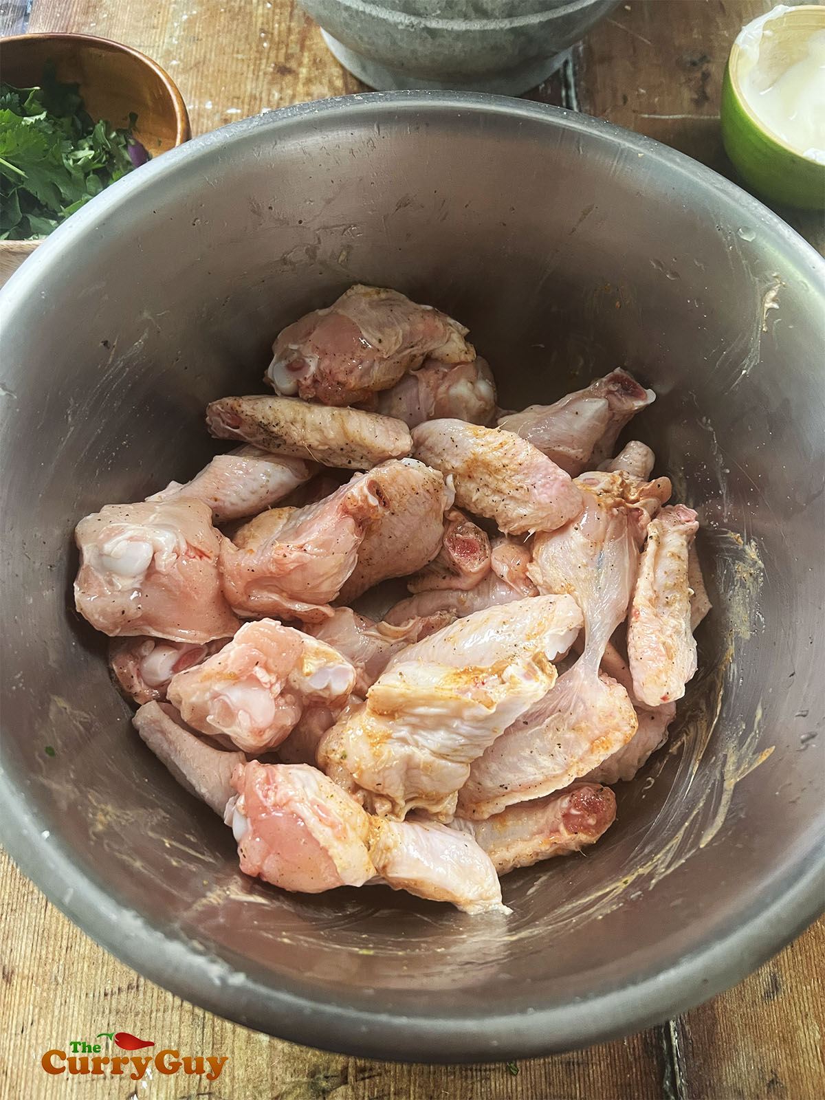 Season the chicken wings with salt and pepper, Squeeze in the juice of one lime and stir to coat.