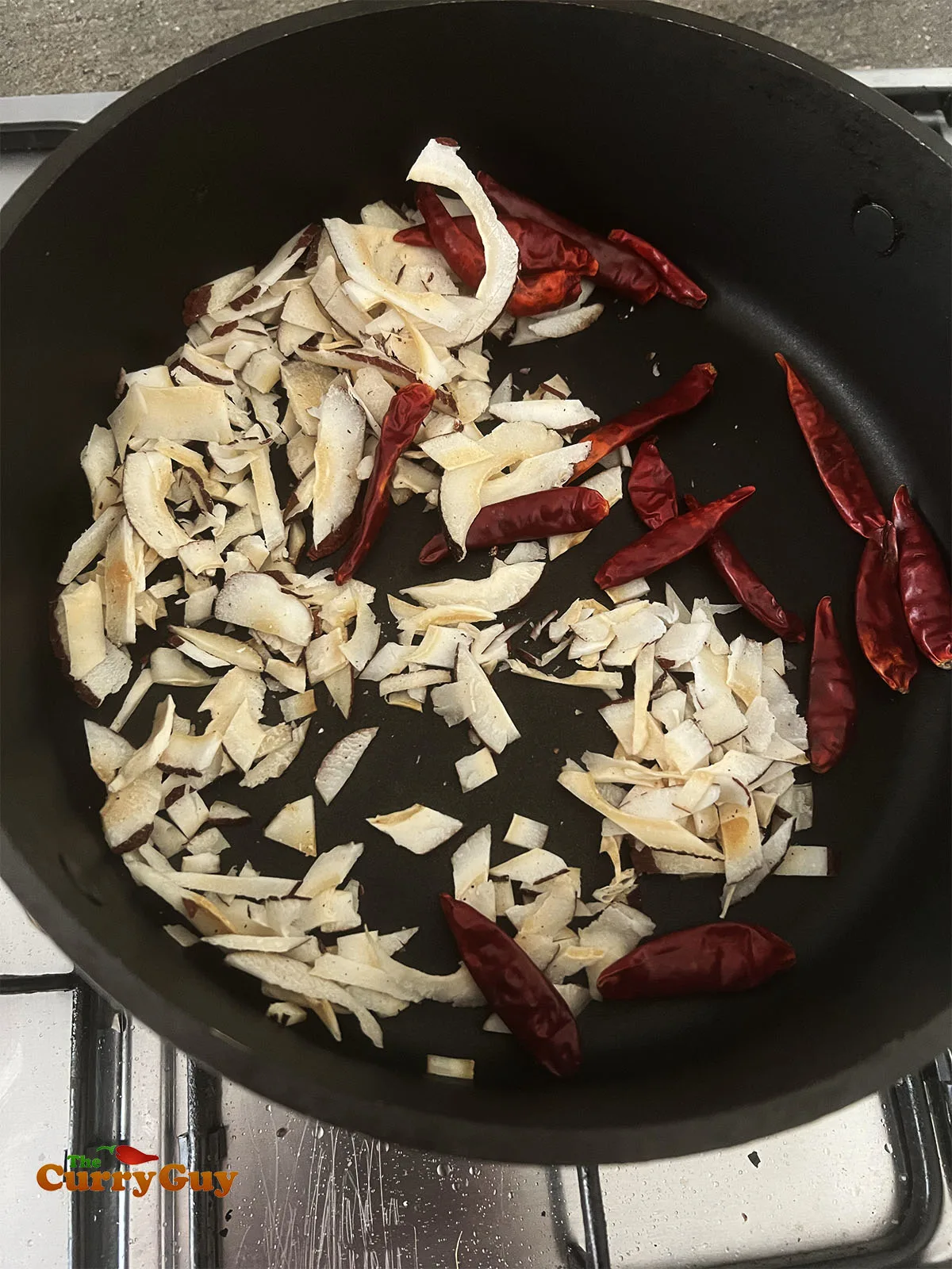 Toasting coconut flakes and chillies.