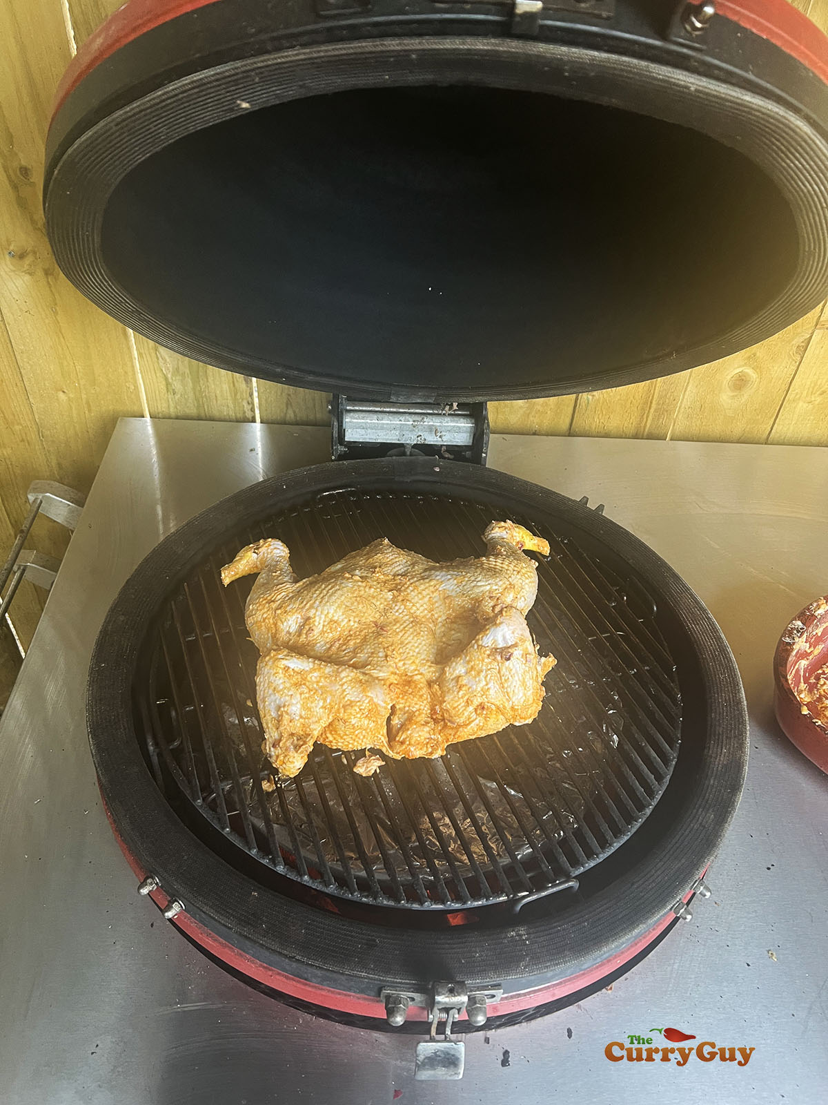 Placing the chicken on the barbecue.