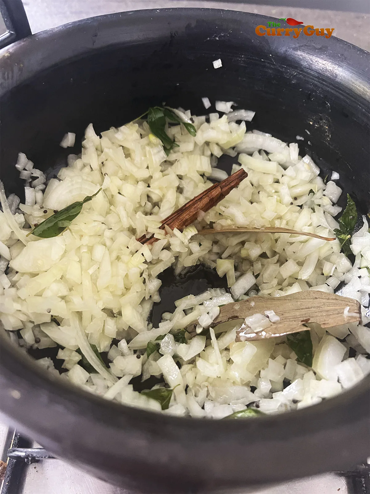 Adding the chopped onion to the pot.