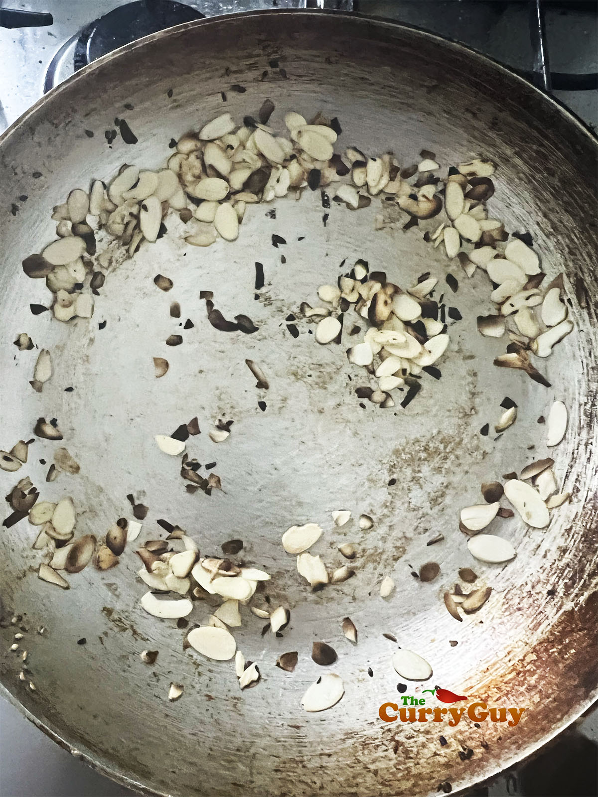 Toasting coconut flakes in the pan.