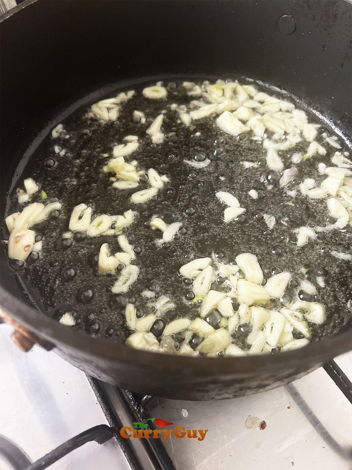 Frying slivered garlic.