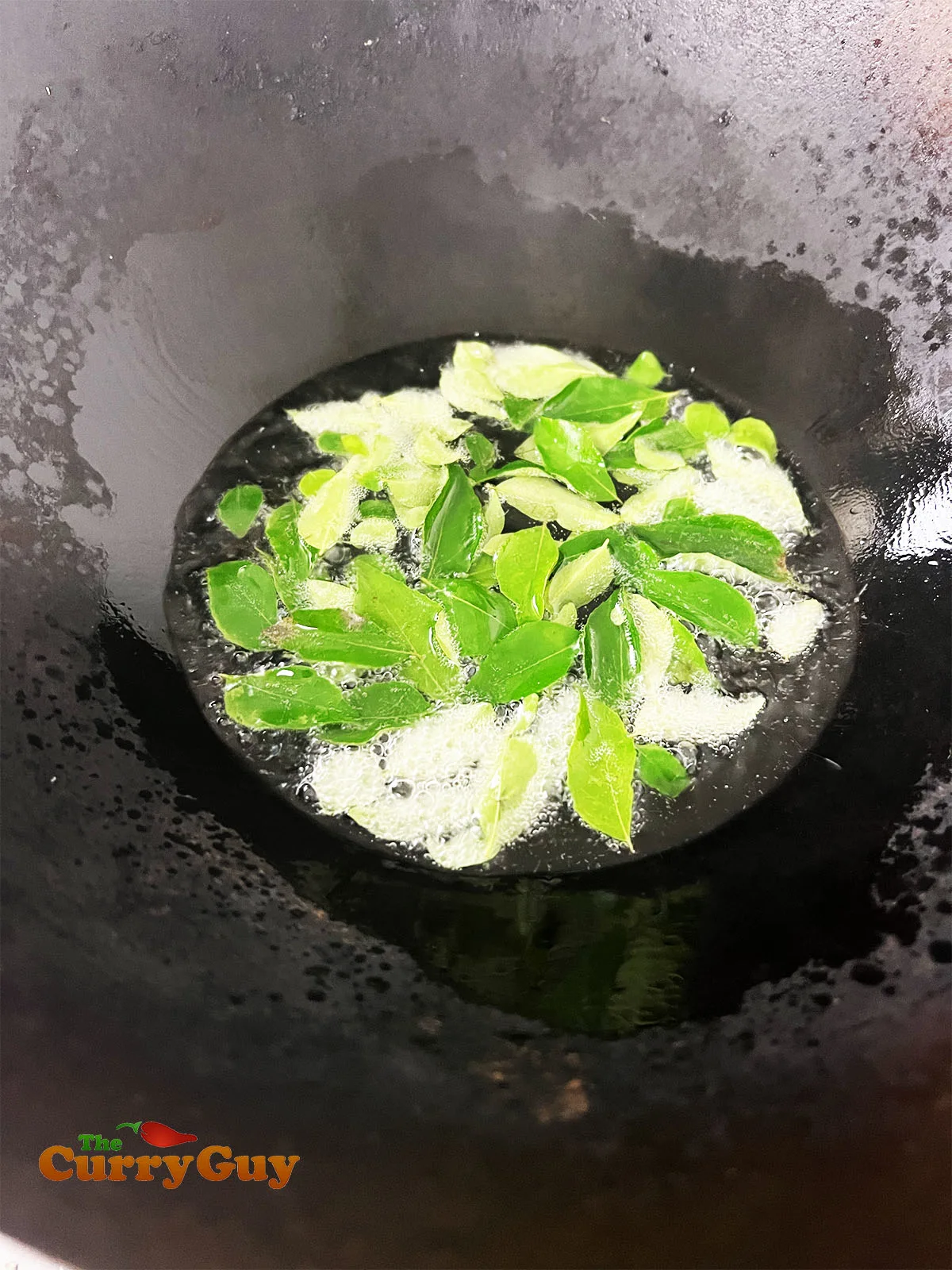 Frying the curry leaves.