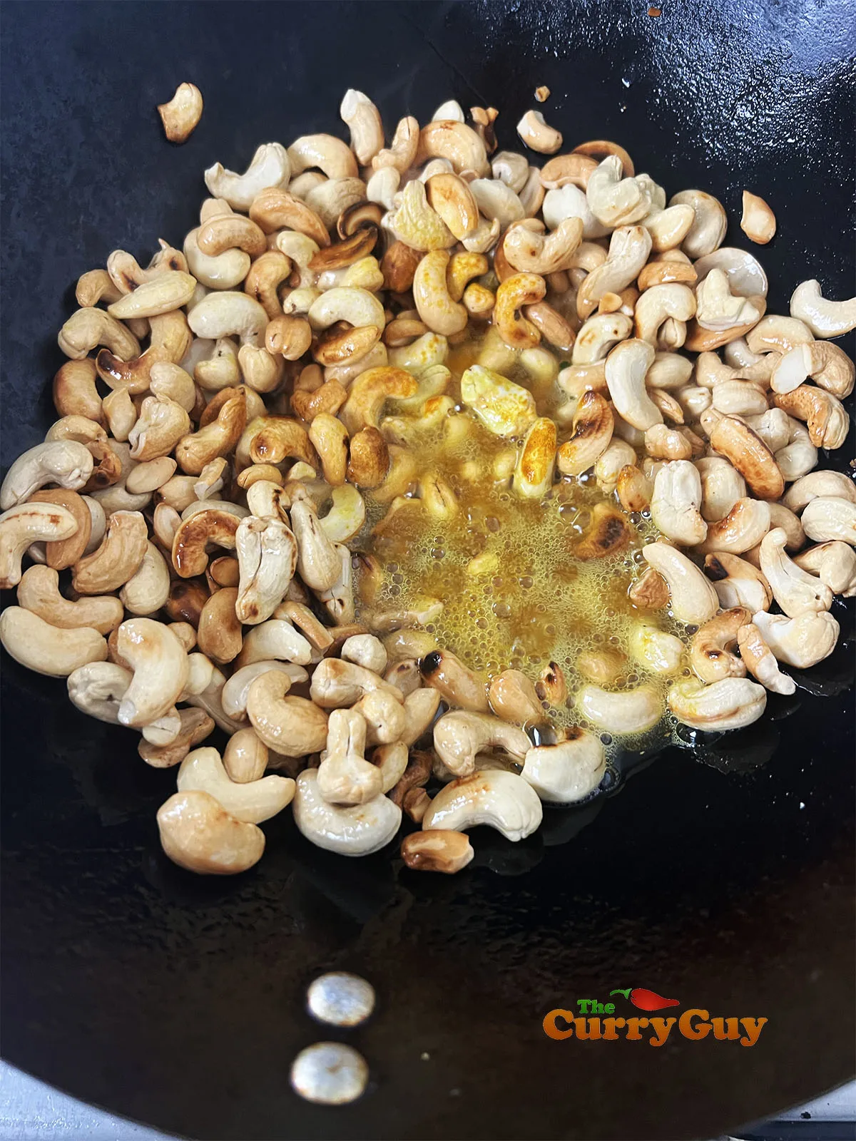 Frying the cashews and adding turmeric