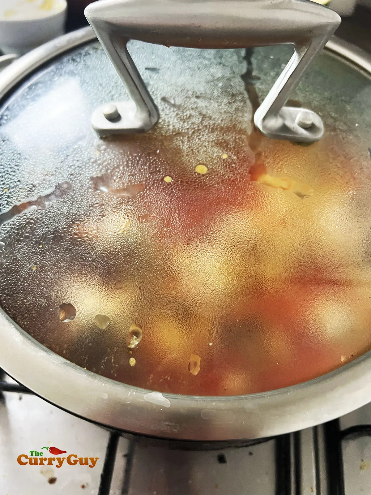 Simmering the curry with the lid on.