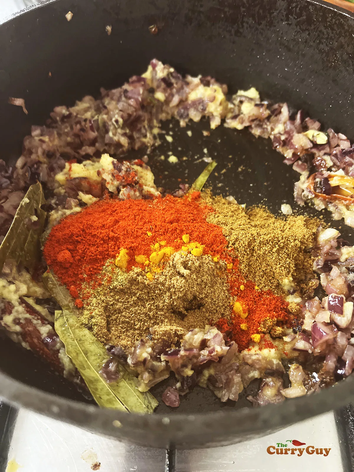 Adding the ground spices to the pan