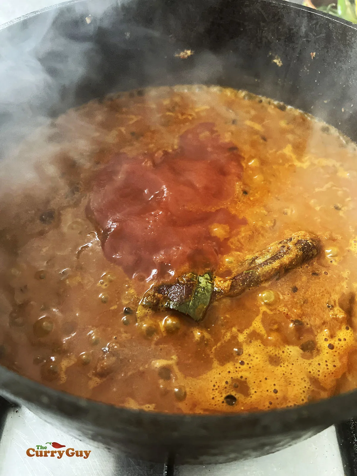 Adding passata to the pan