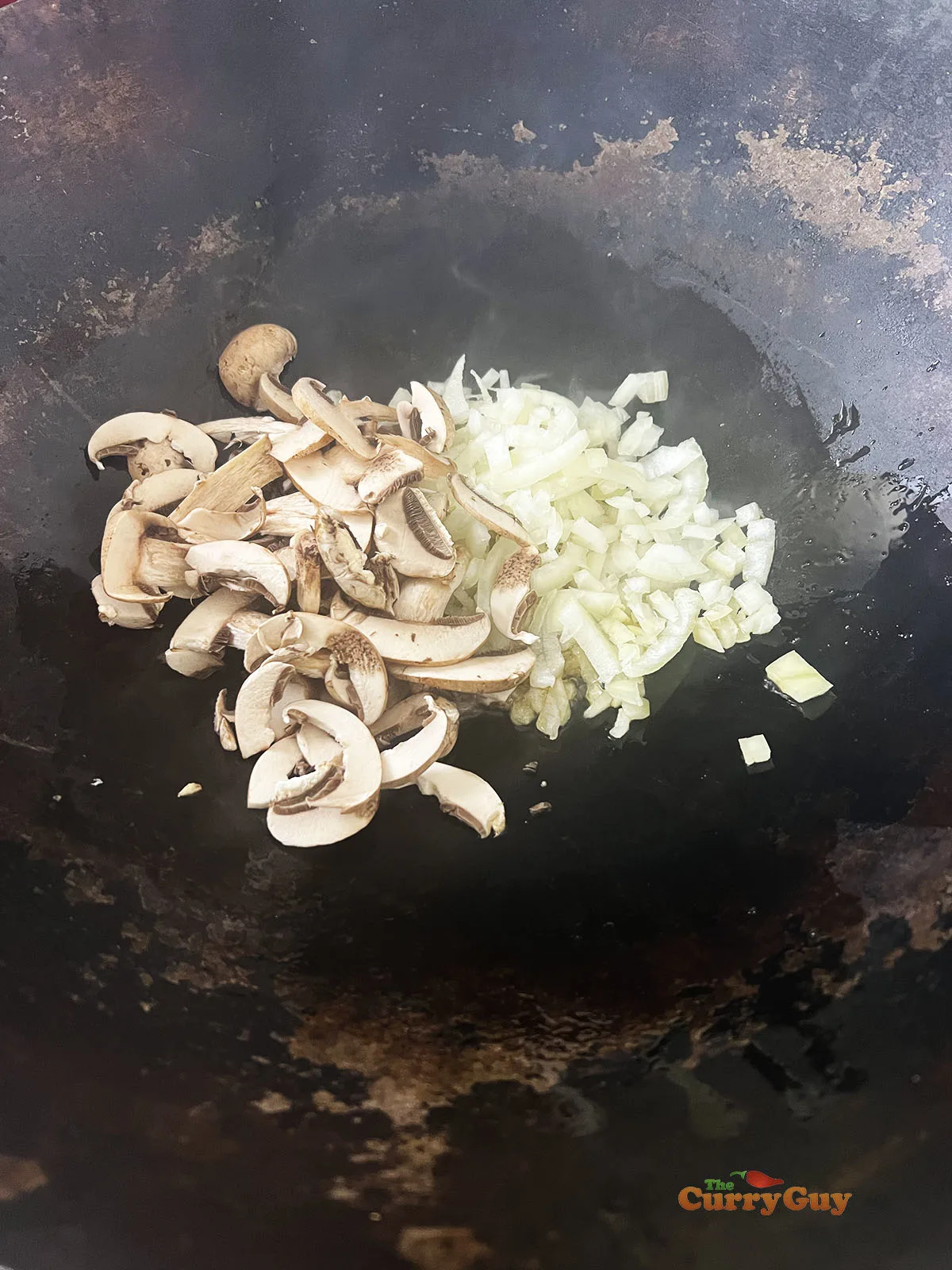 Frying onions and mushrooms in sesame oil.
