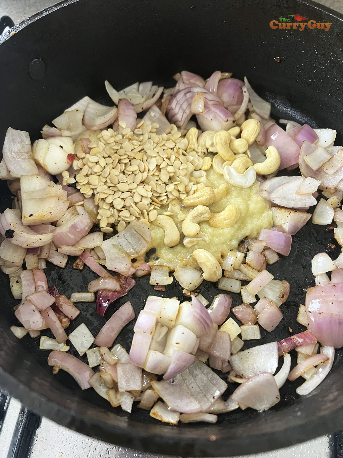 Frying the onions, melon seeds, cashews and garlic and ginger paste.