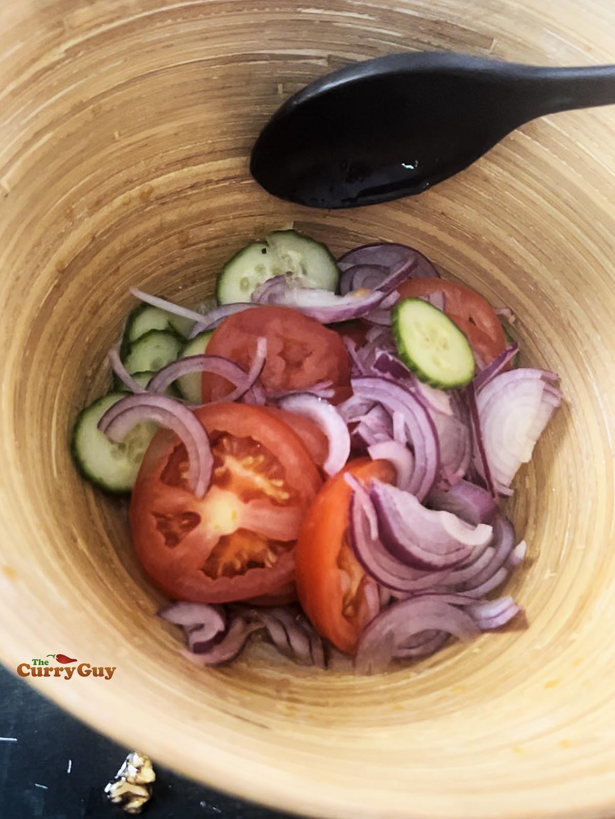 Tomatoes, cucumber and onions in a salad bowl.