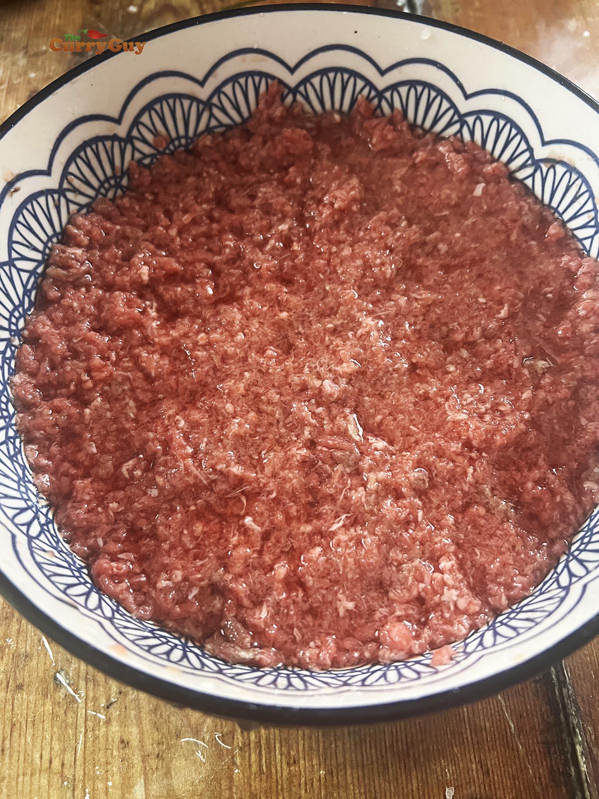 Soaking beef in water in a mixing bowl.
