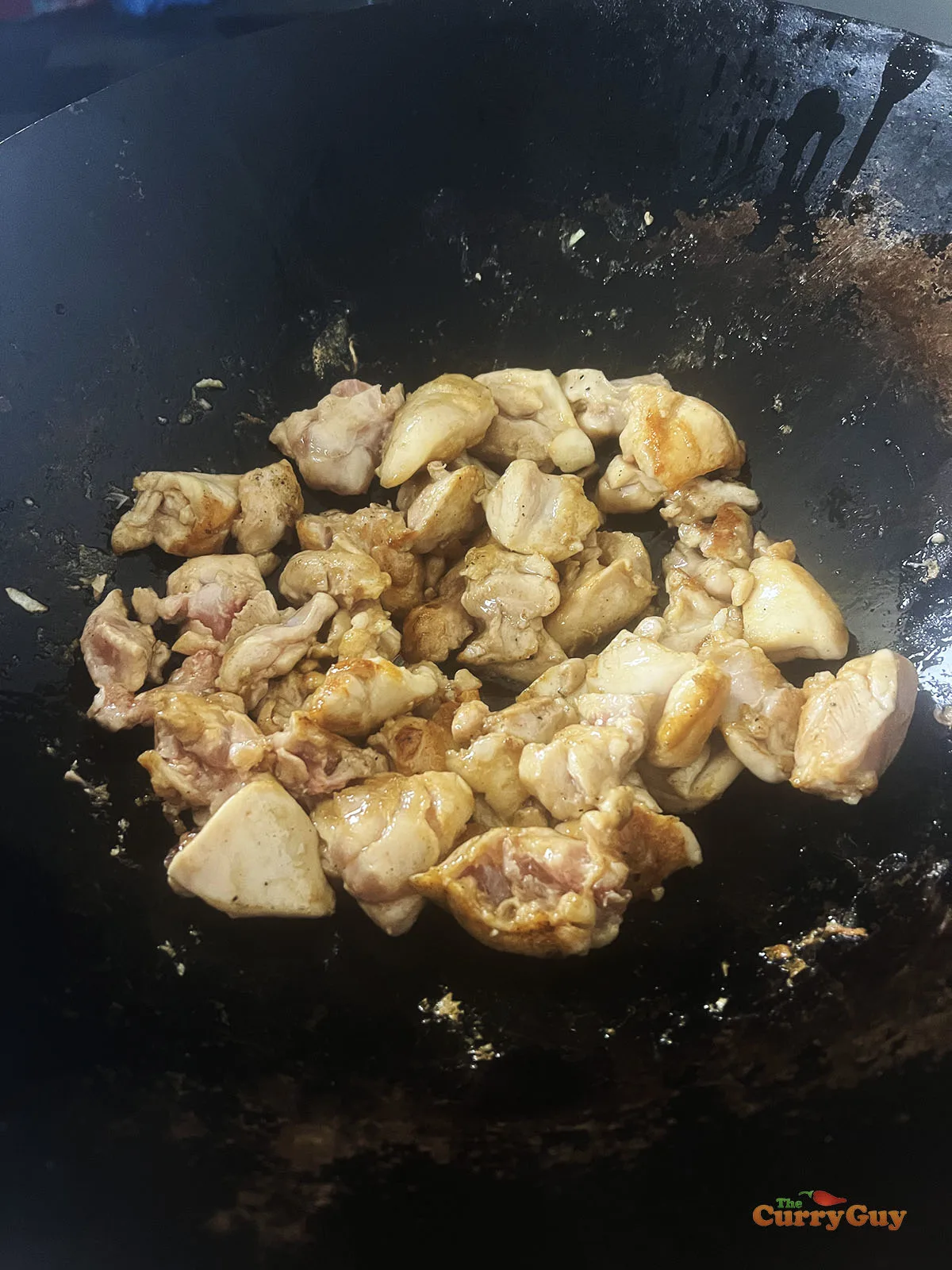 Cooking the other side of the chicken pieces.