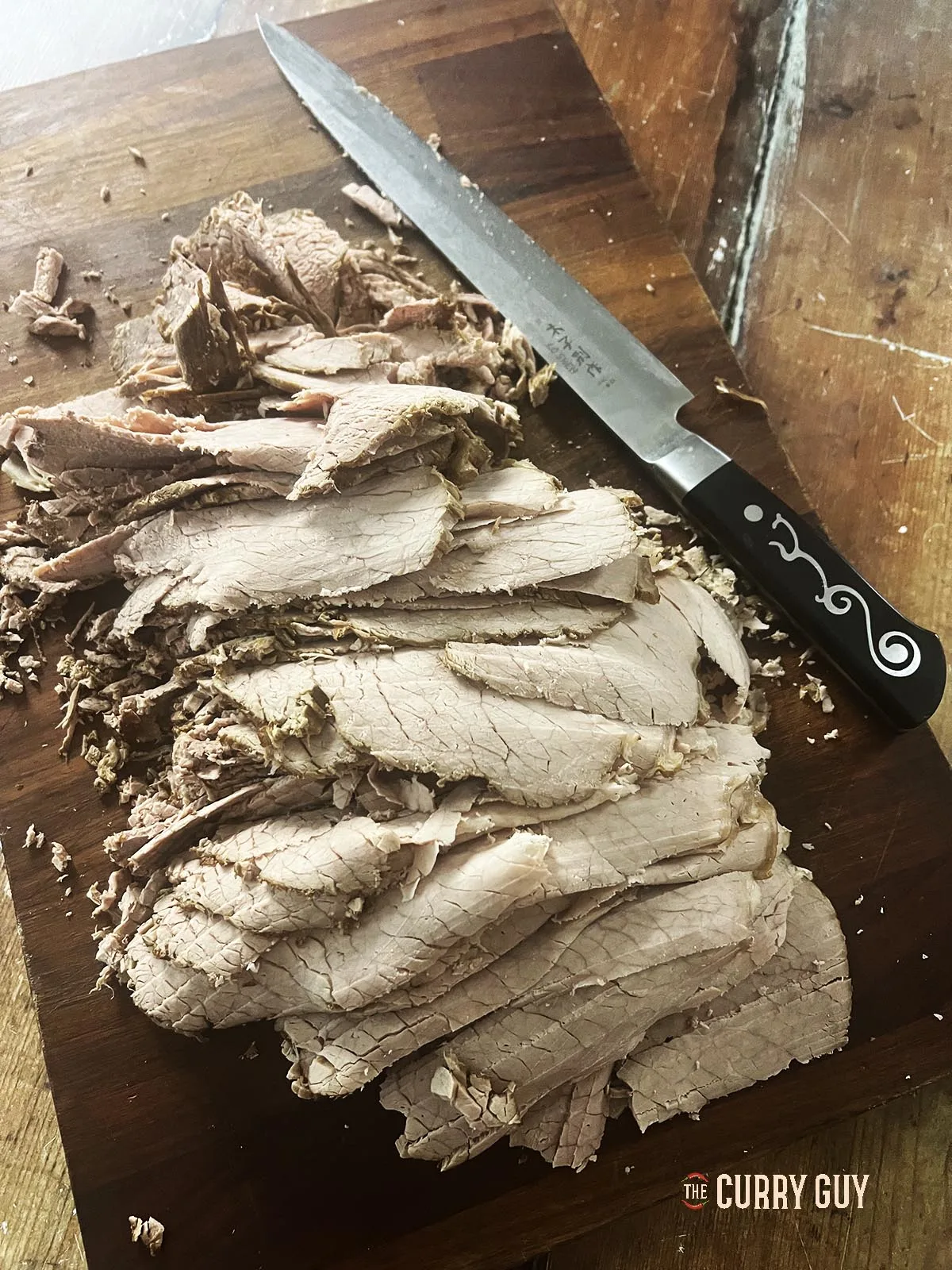 Beef sliced thinly for stacking on the sandwiches.