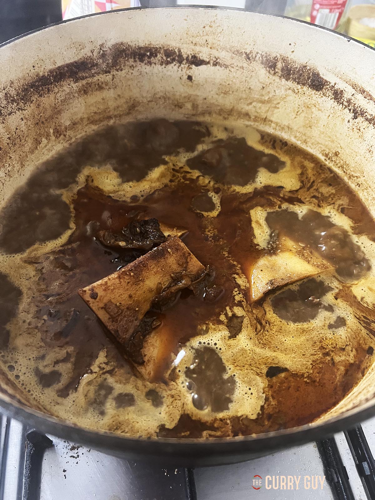 Reducing the sauce by half in the pot. 