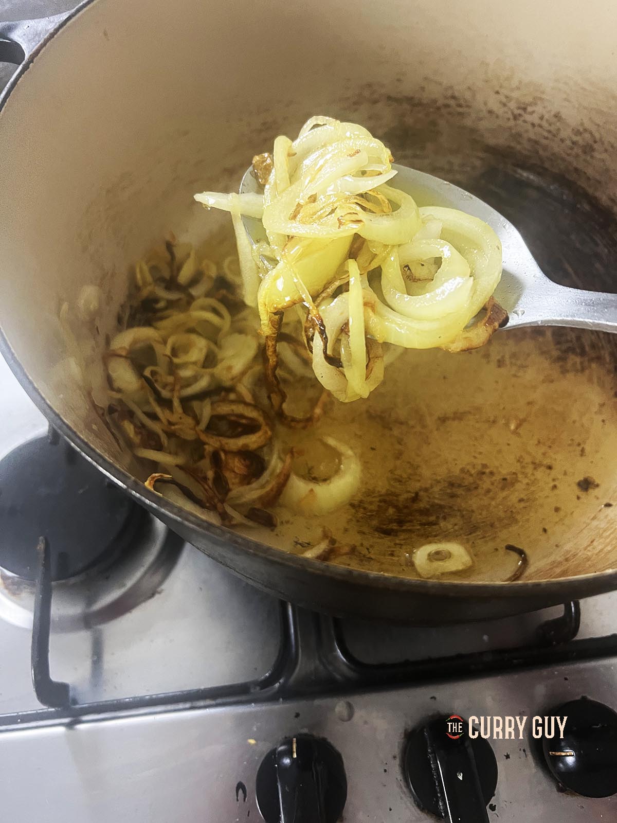 Transferring the onions and garlic to a plate.