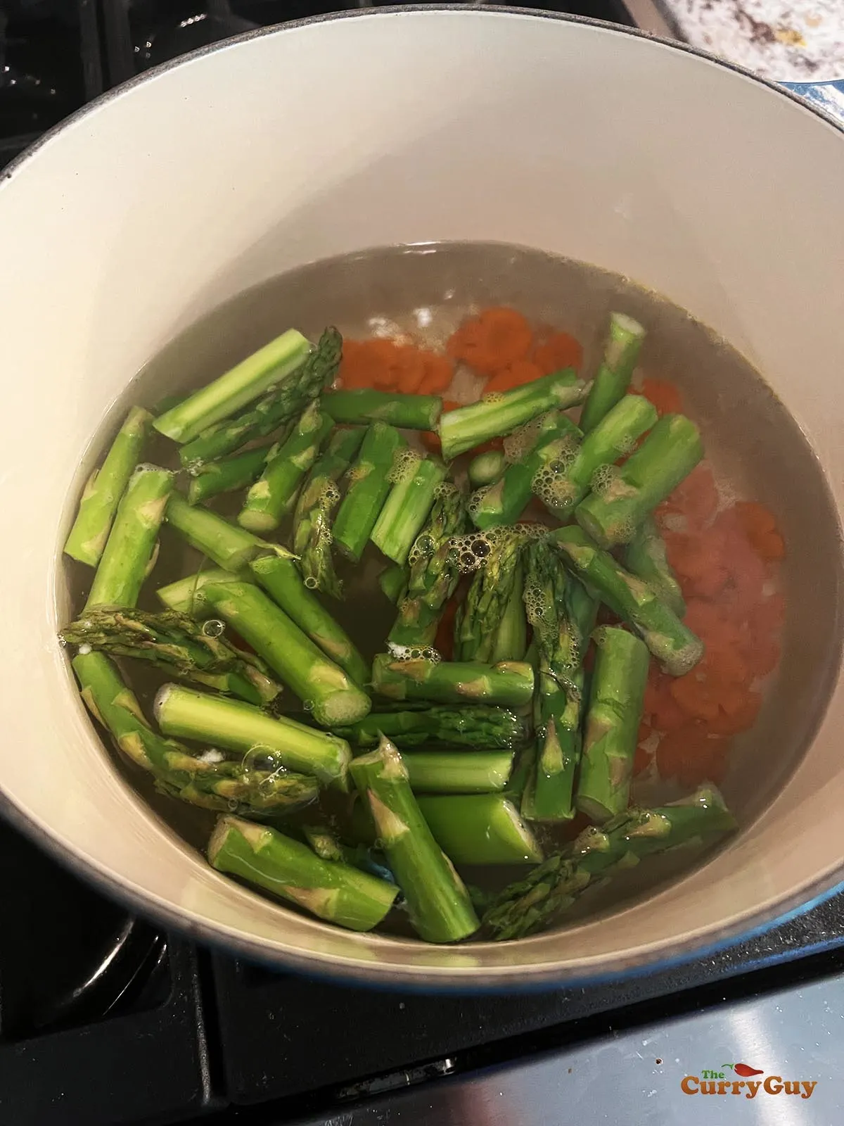 Blanching the carrots and asparagus.