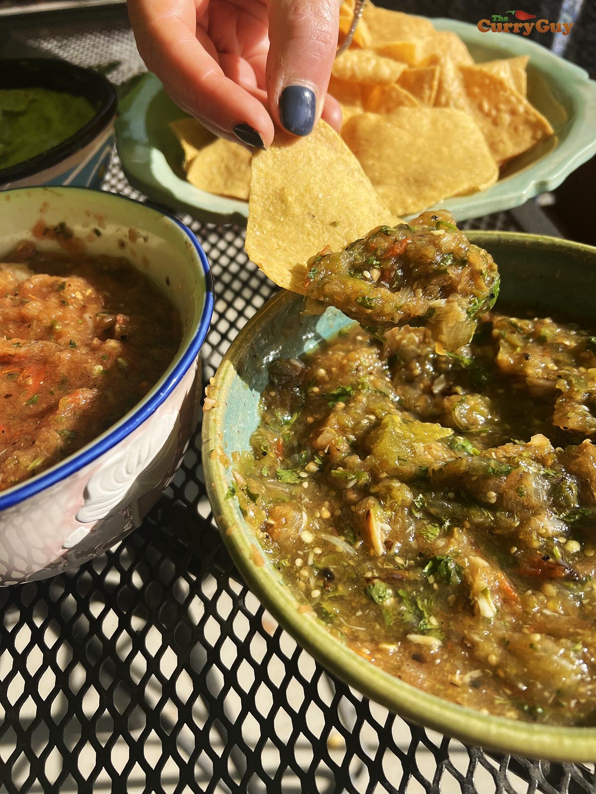 Tomatillo and tomato salsa served with corn chips and other salsas.