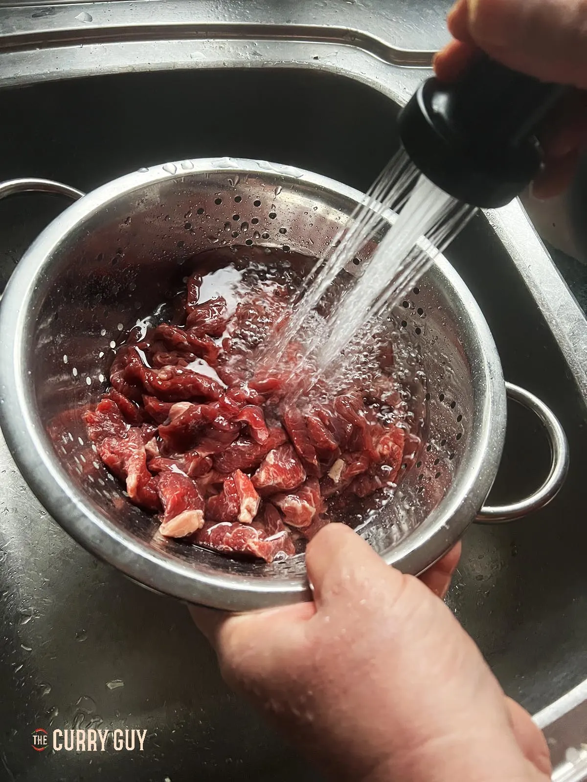 Washing the bicarbonate of soda (baking soda) off the meat.