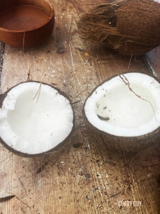 Separating the coconut halves.