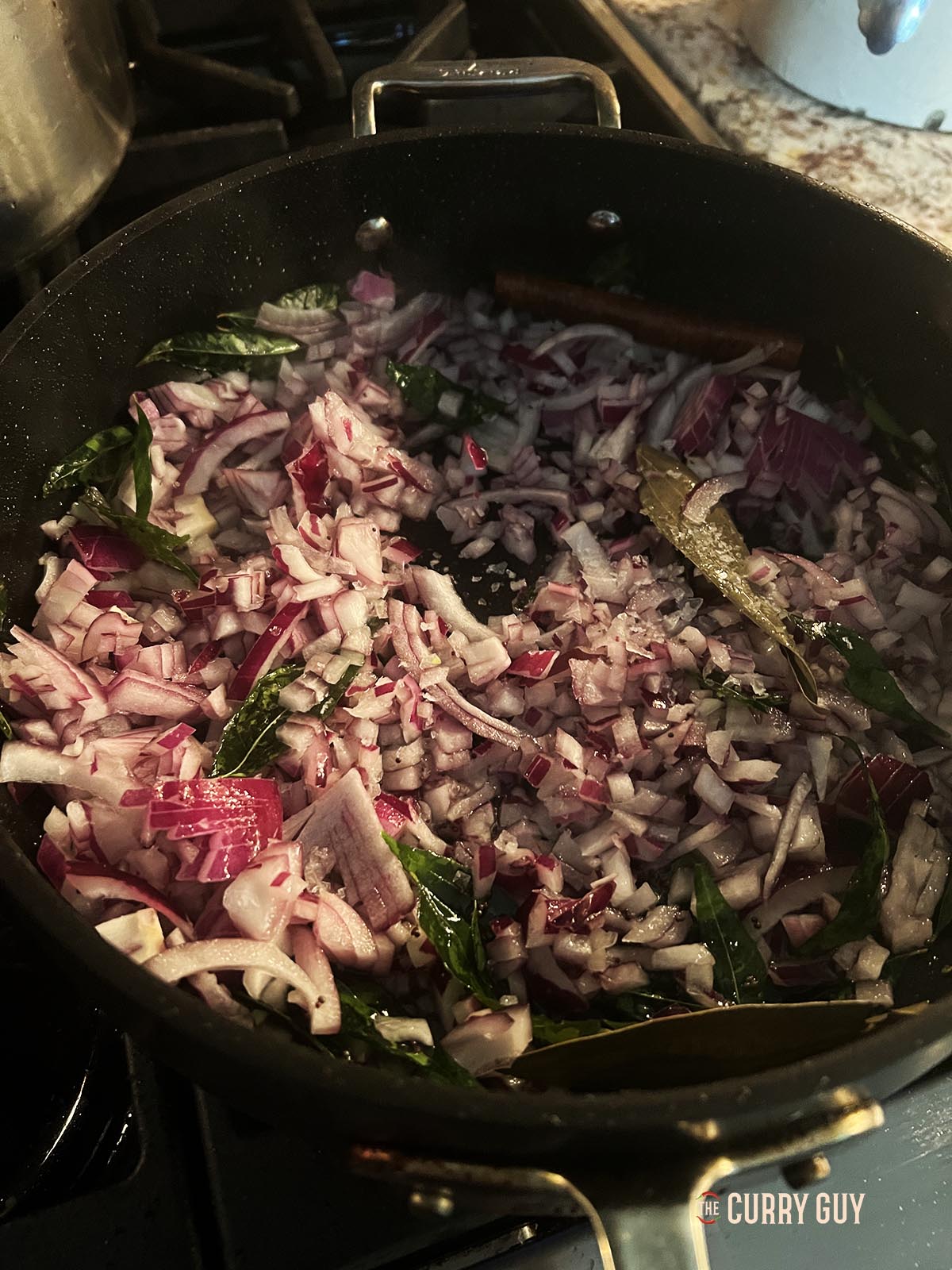 Adding the chopped onions to the pan