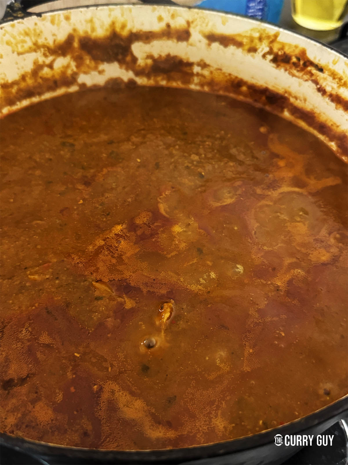 The ghee rising to the top of the sauce.