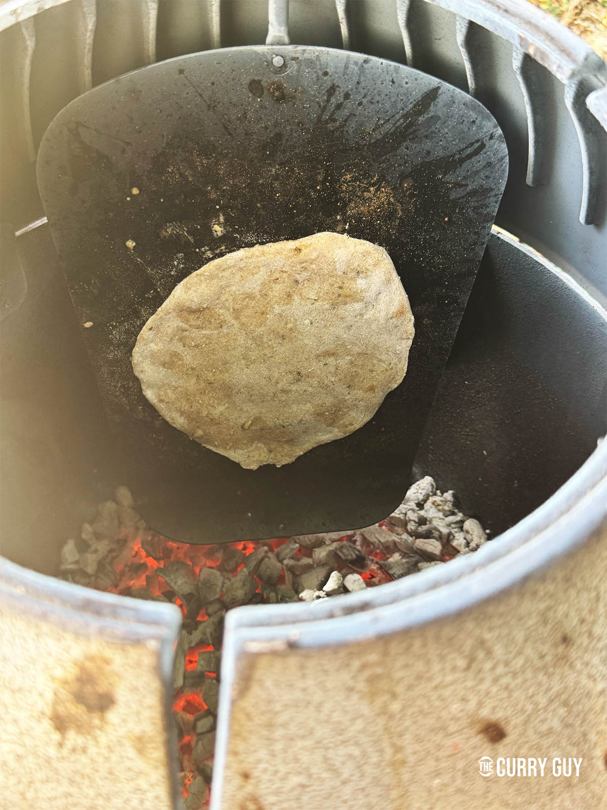 Cooking the roti in a tandoor oven