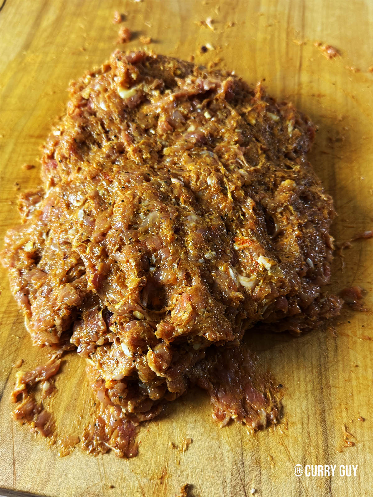 Working the meat mixture together until well combined.