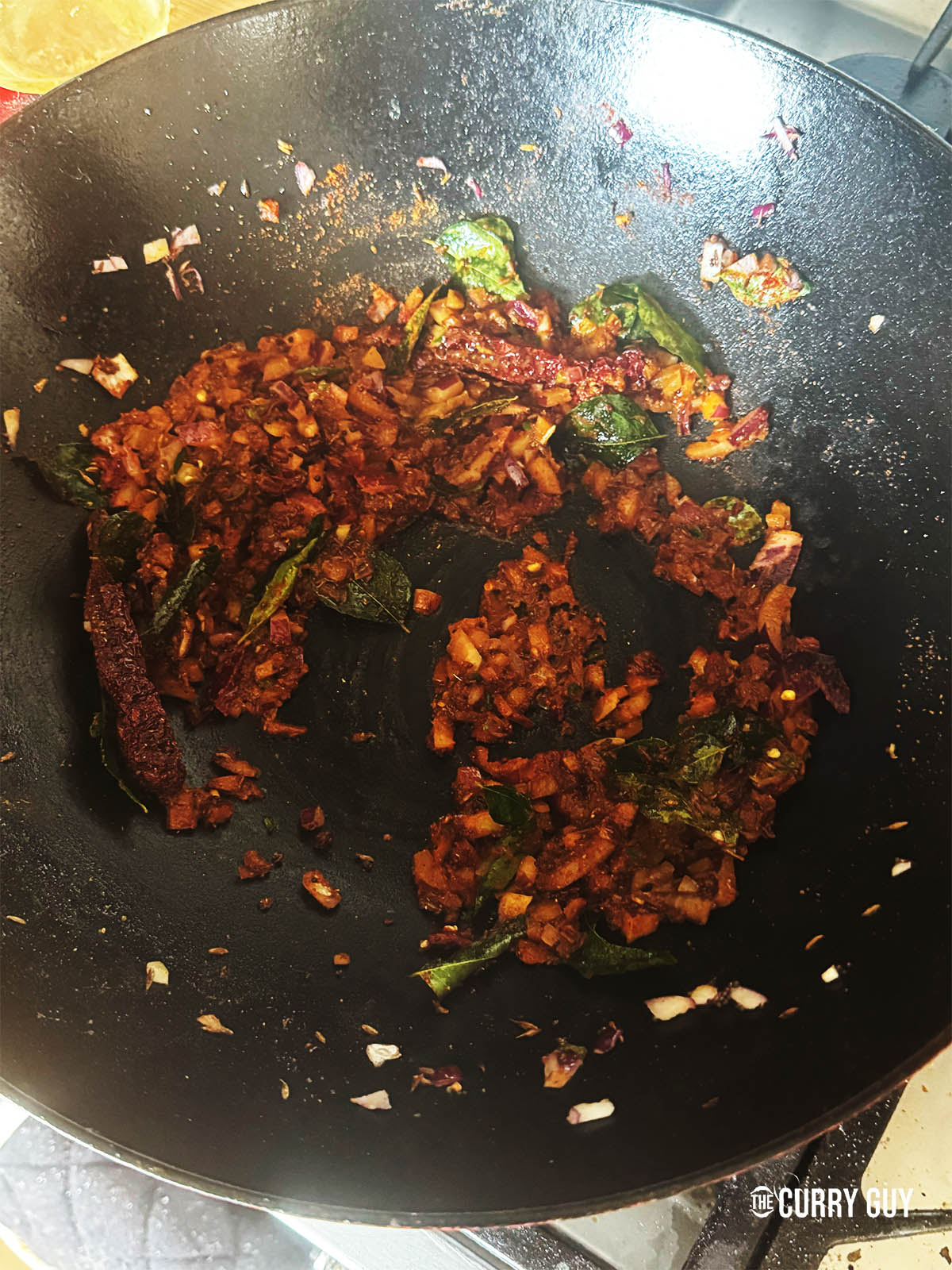 Stirring the ground spices into the onion mixture. 