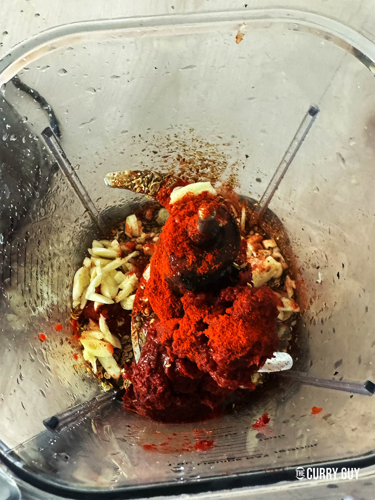 Placing all of the ingredients except for the soaking chillies in a blender to blend to a paste.