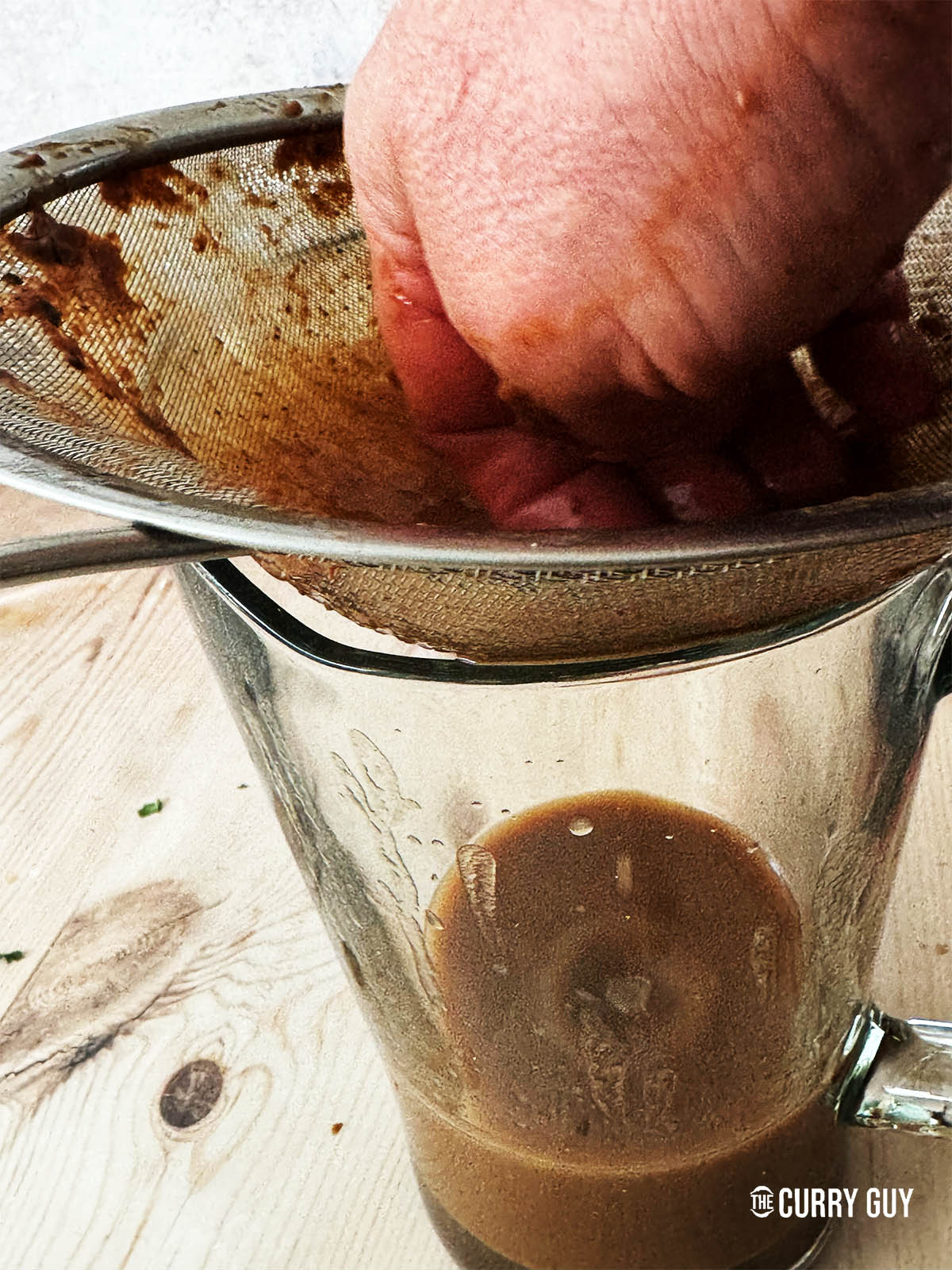 Running the tamarind through a sieve.