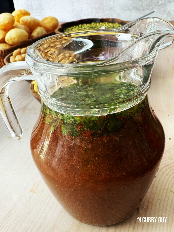 Tamarind water in a pouring jug.