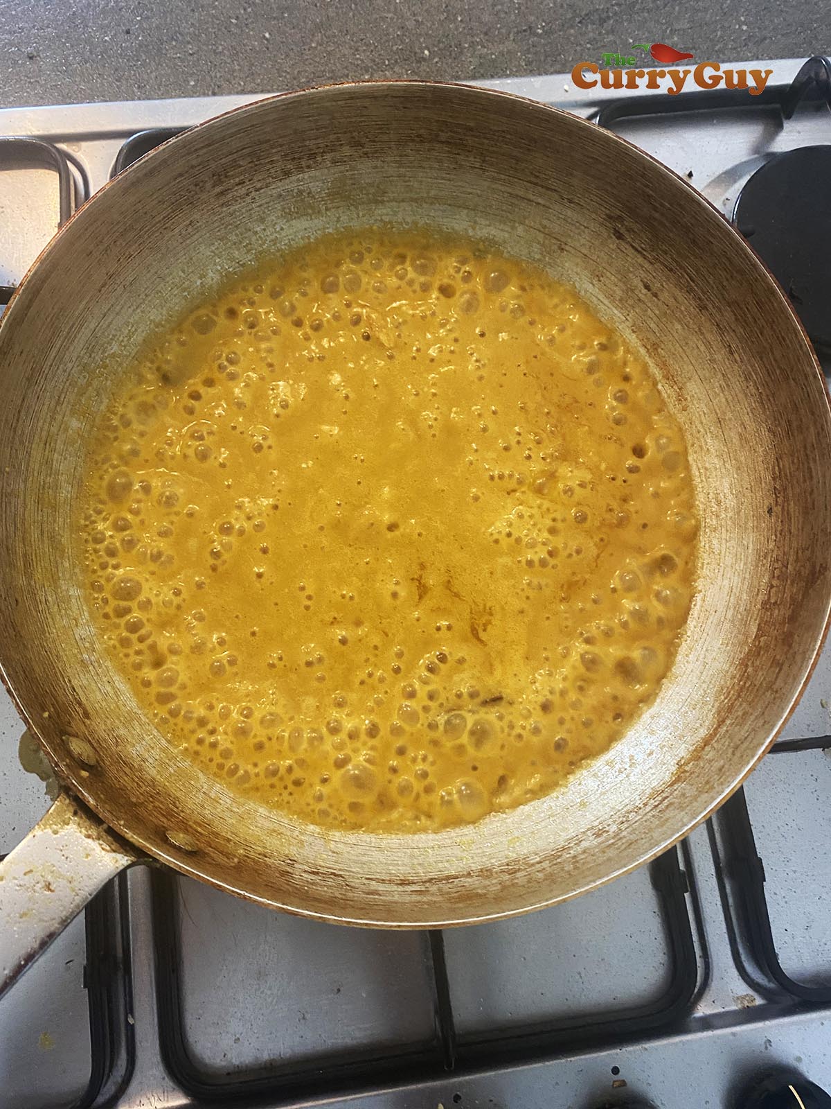 adding sauce to the curry