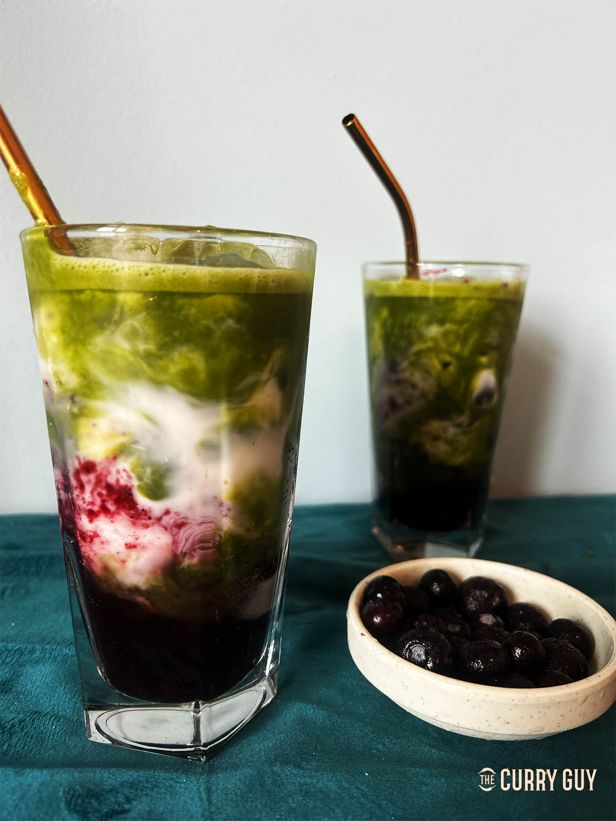 Adding the matcha over the blueberry syrup and milk. 