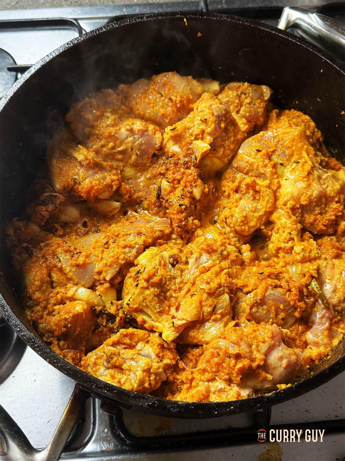 Ajout du poulet avec sa marinade dans la poêle.
