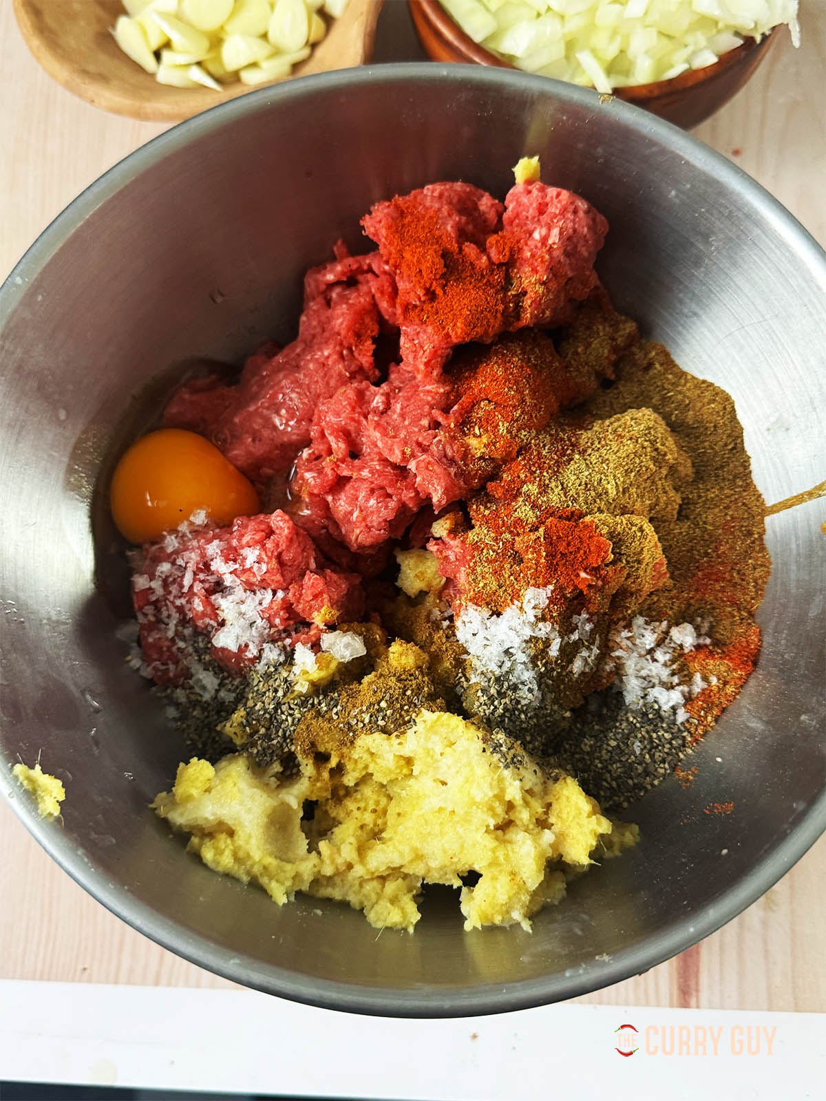 The meat and marinade ingredients in a mixing bowl. 