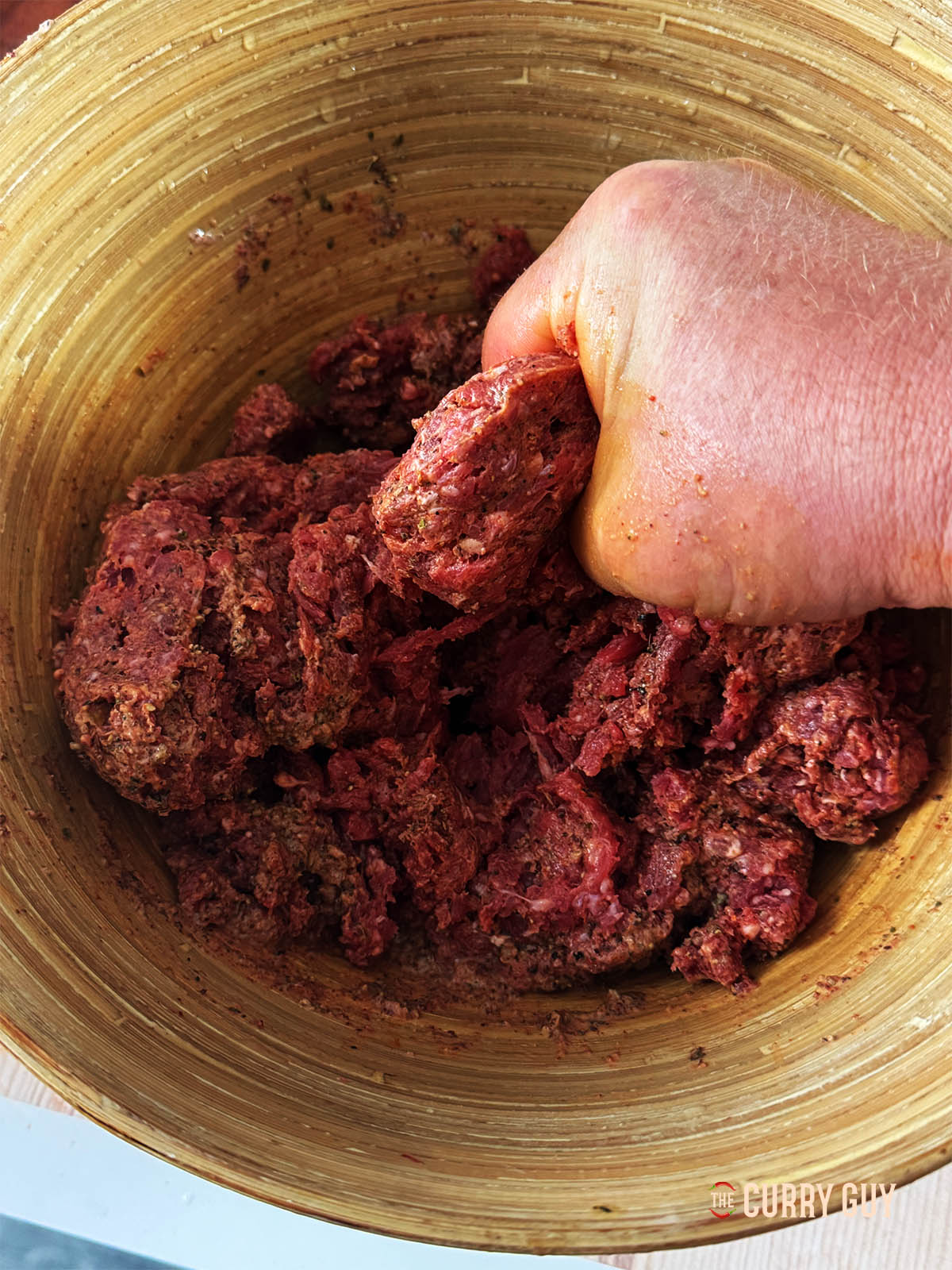 Mixing the meat with the marinade.