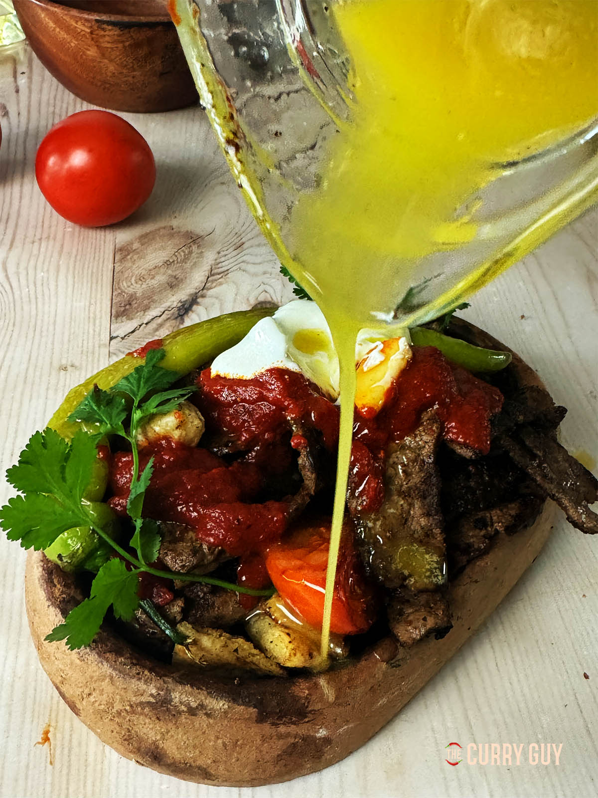 Pouring butter over an iskender kebab