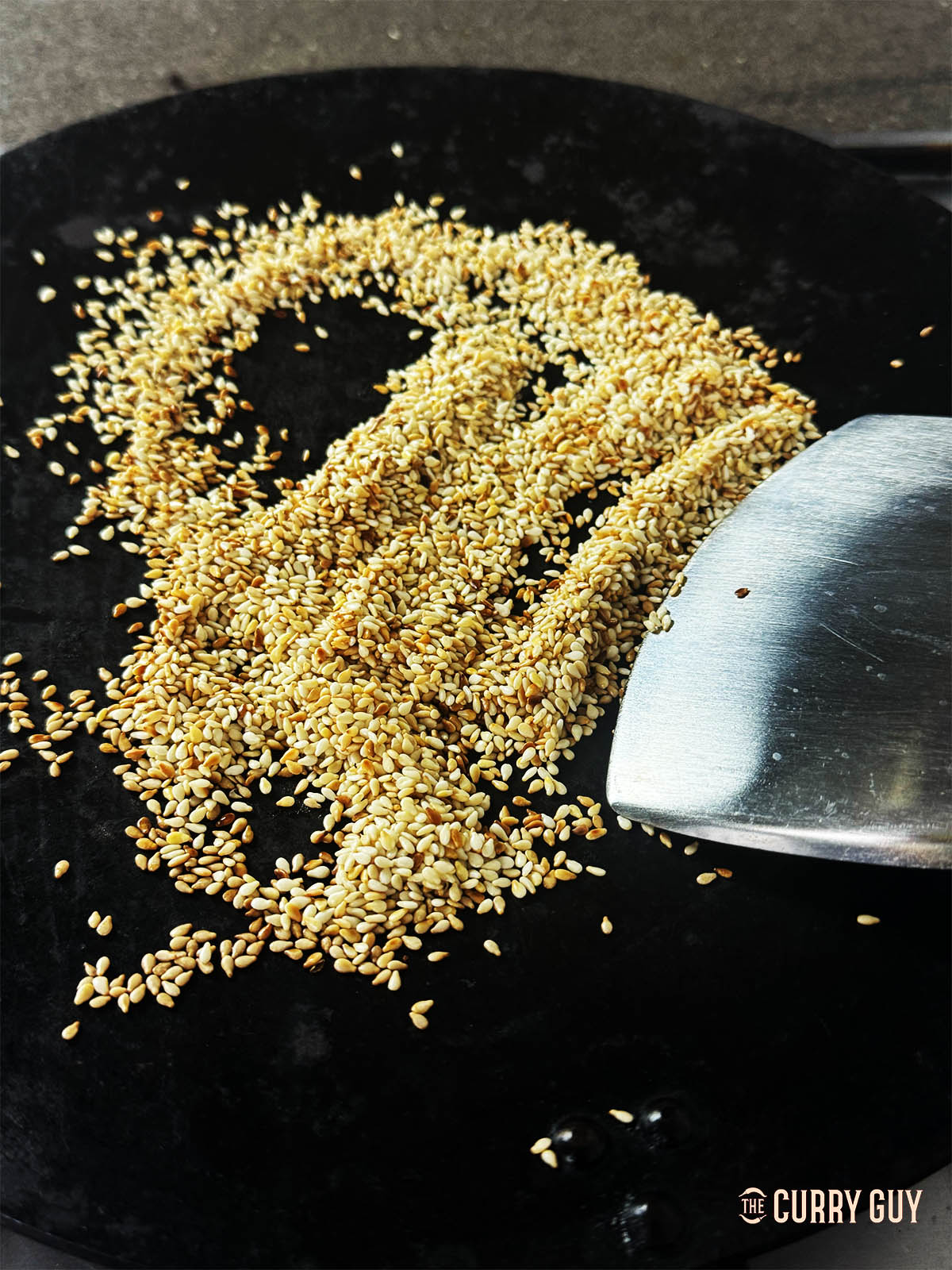 Toasting the sesame seeds in a dry frying pan until golden brown and fragrant.