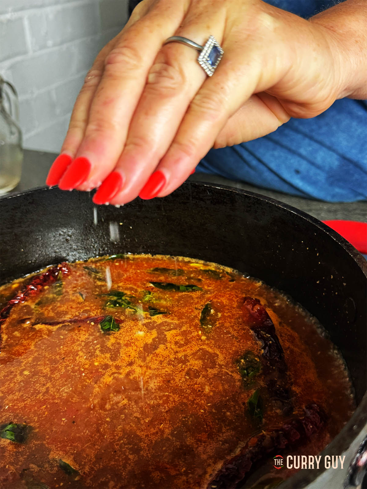 Gently simmering the rasam and adding salt to taste before serving.
