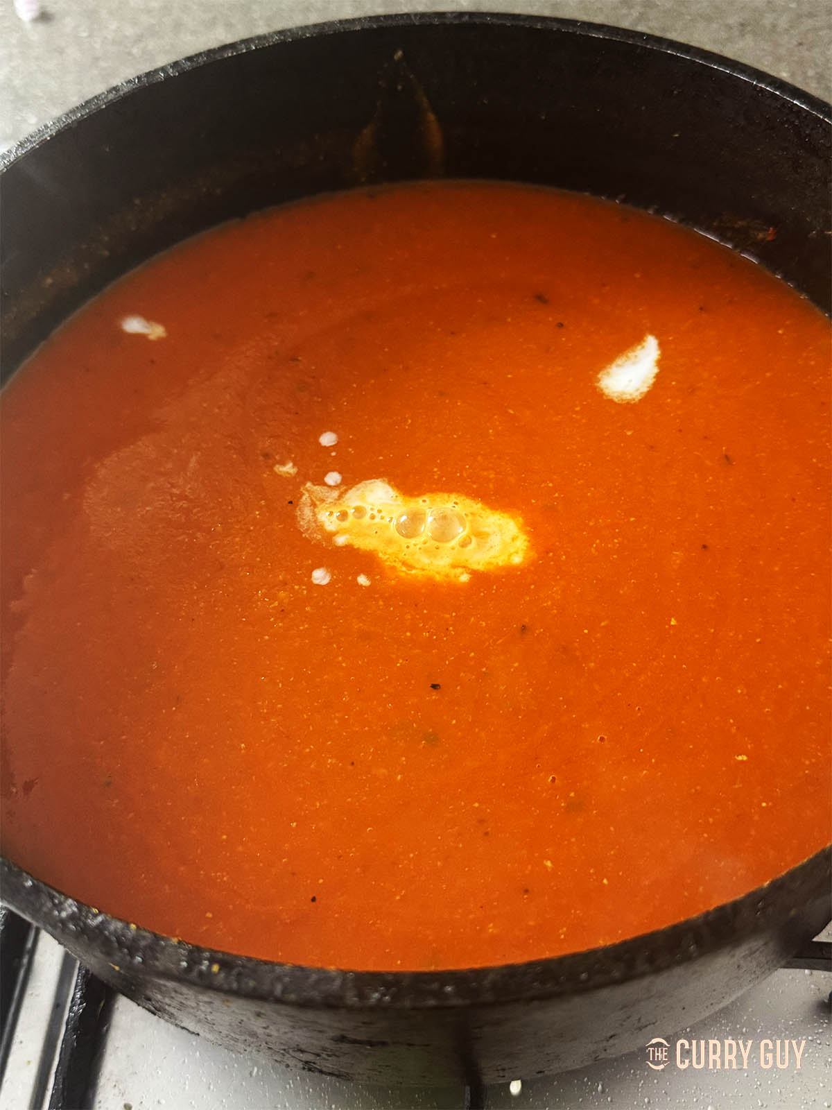 Adding coconut milk and lime juice to the soup. 