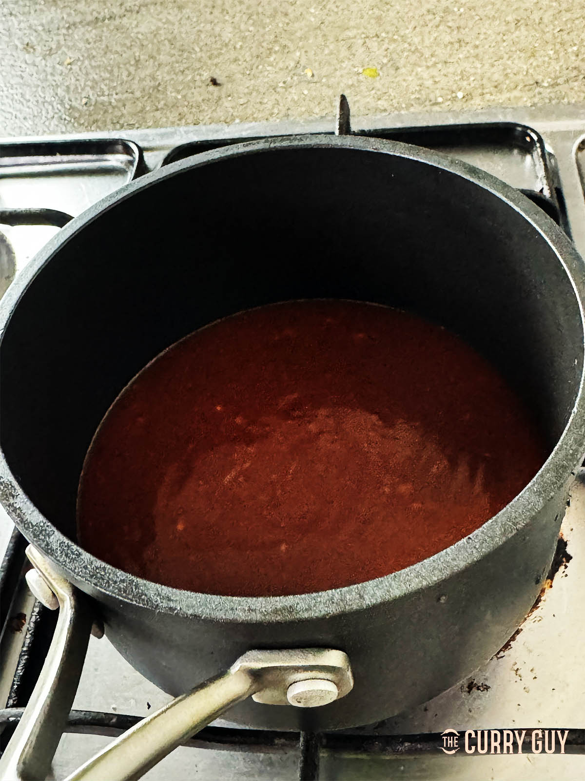 Heating the sauce in a saucepan.