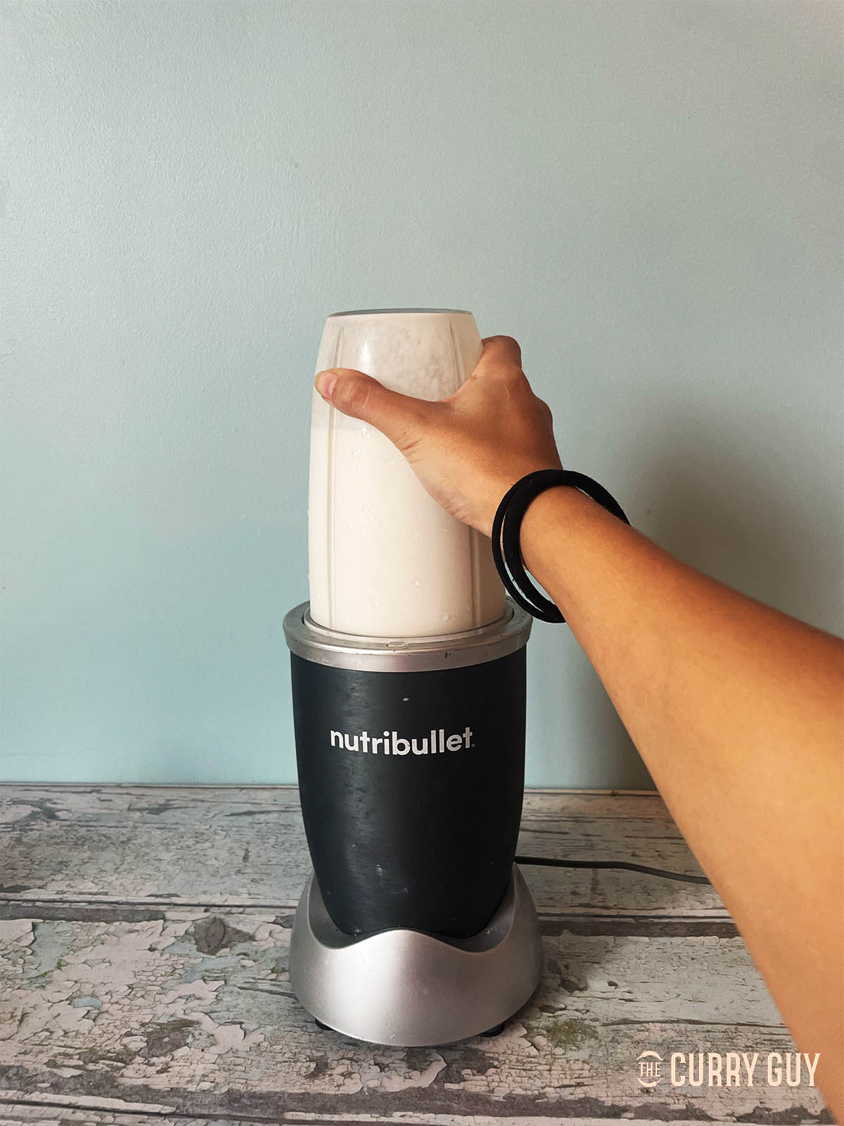 Blending the coconut milk, condensed milk and ice until smooth.