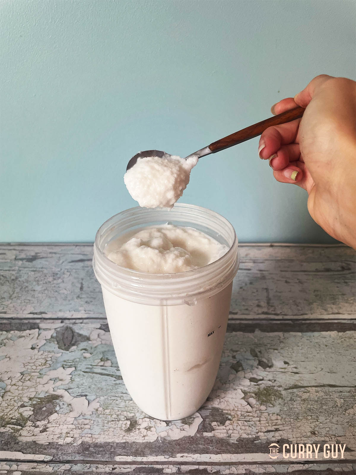 The slushy coconut and evaporated milk on a spoon.