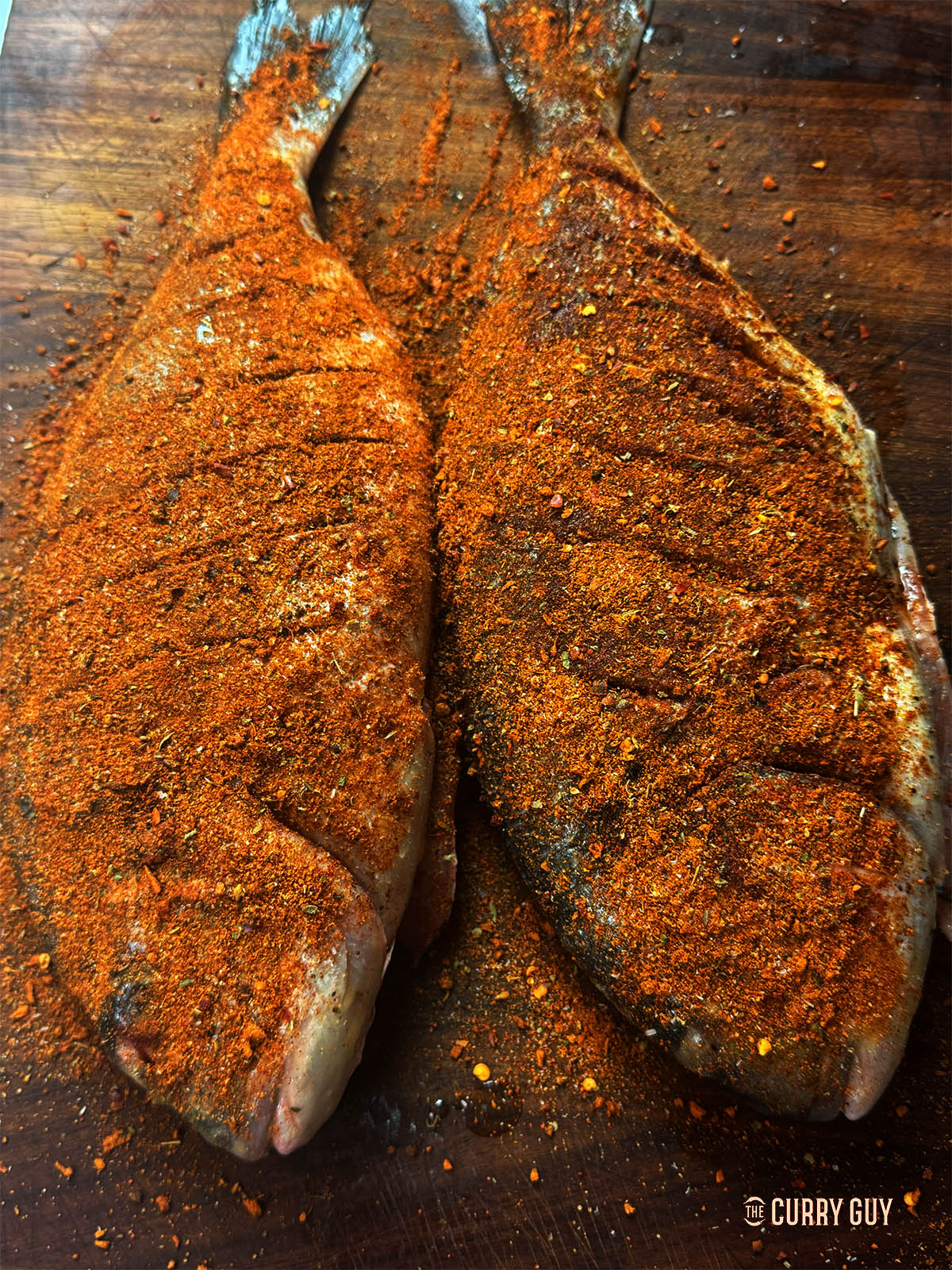 The fish coated with Cajun seasoning before cooking.